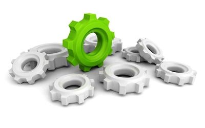Cogwheel Gears With One Green Concept Leader